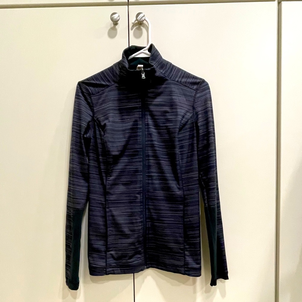 Under Armour full zip, mock neck jacket in a black and gray horizontals stripe.